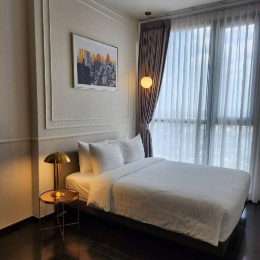 Modern bedroom with a window and white curtains