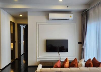 Modern living room with wall-mounted TV and air conditioner