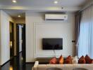 Modern living room with wall-mounted TV and air conditioner