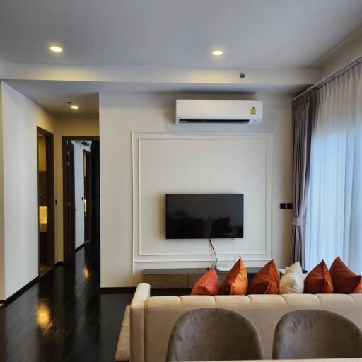 Modern living room with wall-mounted TV and air conditioner