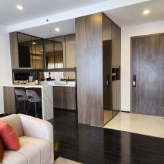 modern living area with open kitchen and bar stools