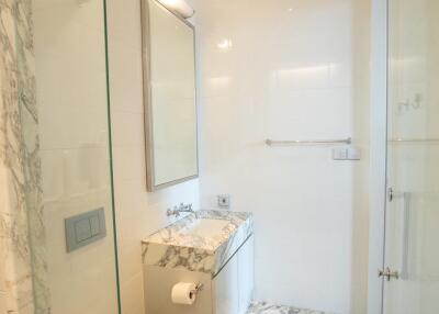 Modern bathroom with marble flooring and glass shower