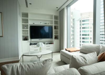 Modern living room with large TV and city view