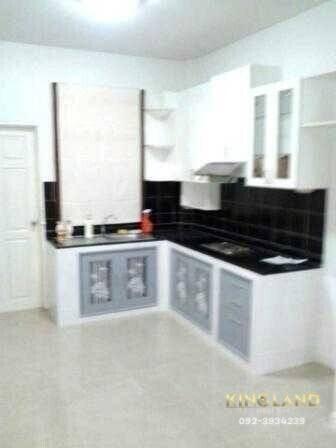 Modern kitchen with white cabinets and black backsplash