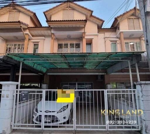 Front view of a townhouse with a covered garage