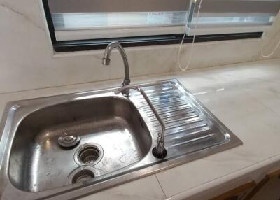 Modern kitchen sink with marble countertop