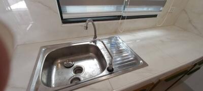 Modern kitchen sink with marble countertop