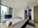 Modern bedroom with bed, large window, TV, and urban skyline view