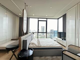 Modern bedroom with large windows and city view