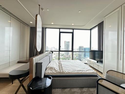 Modern bedroom with large windows and city view