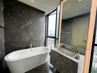 Modern bathroom with freestanding tub and large window