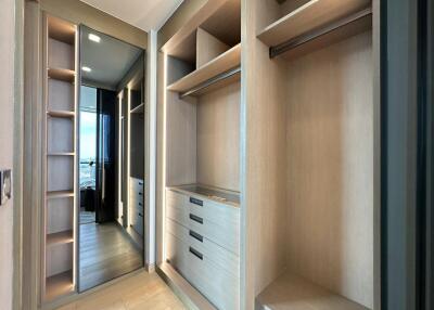 Spacious walk-in closet with built-in shelves and drawers