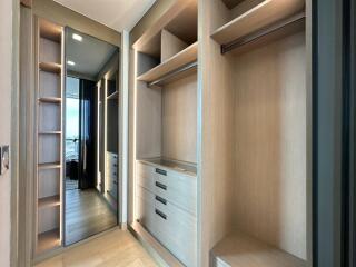 Spacious walk-in closet with built-in shelves and drawers