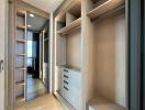 Spacious walk-in closet with built-in shelves and drawers