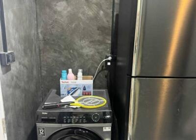 Laundry area with washer and refrigerator