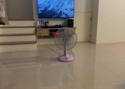 Living room with TV, fan, and tiled flooring