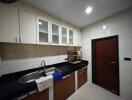 Modern kitchen with wooden cabinets and black countertops