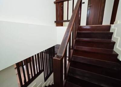 Wooden staircase with handrail and doors