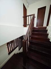 Wooden staircase with handrail and doors