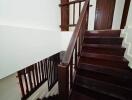 Wooden staircase with handrail and doors