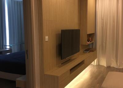 Modern living room with wooden accents and built-in TV unit