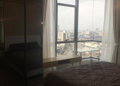 Bedroom with large window and city view