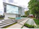 Modern two-story house with large windows and outdoor pool