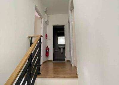 Modern hallway with wooden flooring and stairs