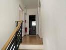 Modern hallway with wooden flooring and stairs