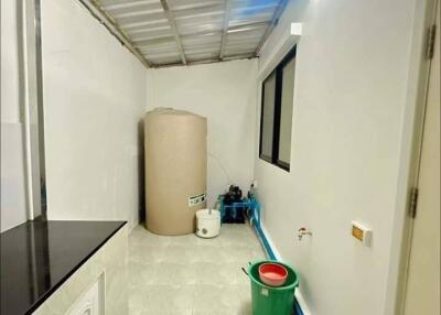 Utility Room with Water Storage Tank and Plumbing