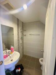 Modern bathroom with sink, mirror, toilet, and shower