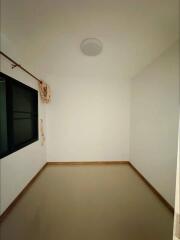 Empty bedroom with a window and white walls