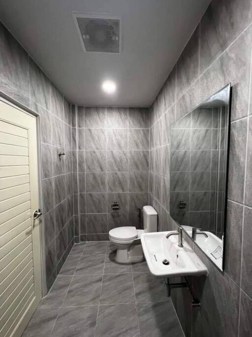 Modern bathroom with tiled walls and floor