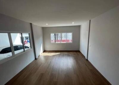 Spacious unfurnished room with large windows and wooden floor