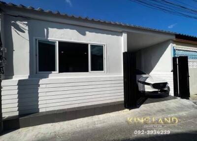 Single story house with a garage and car parked