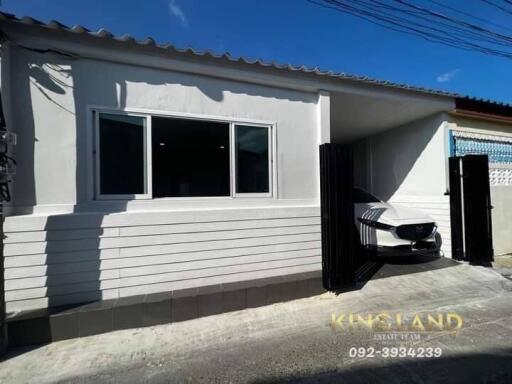 Single story house with a garage and car parked