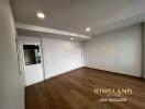 Spacious living room with wooden flooring and recessed lighting