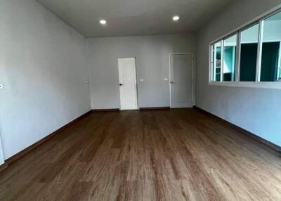 spacious living area with wooden flooring