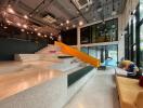 Modern multi-level indoor seating area with glass walls and view of pool