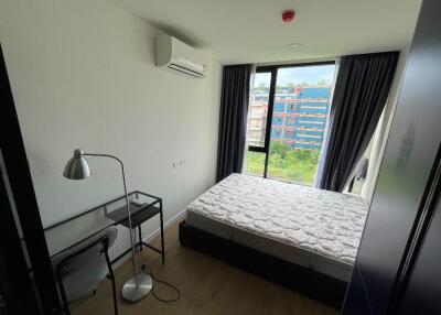 Bedroom with large window and a view