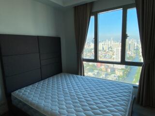 Bedroom with a large window and city view