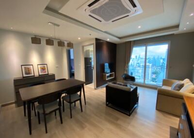 Modern living room with dining area and city view