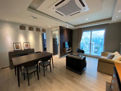 Modern living room with dining area and city view