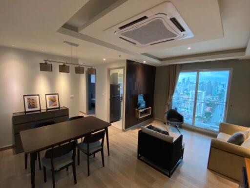 Modern living room with dining area and city view