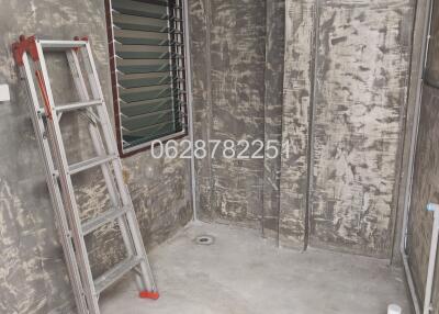 Raw unfinished utility room with ladder and ventilation pipe