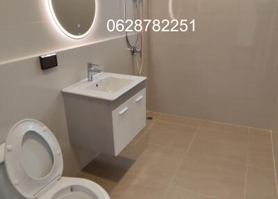 Modern bathroom with toilet and vanity unit