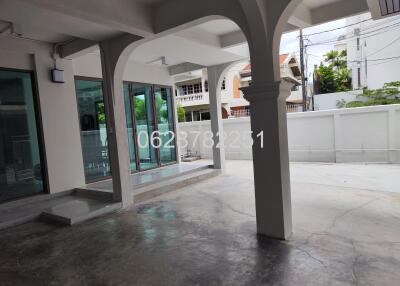 Outdoor area with covered space and glass doors