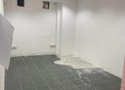 Empty room with tiled floor and white walls