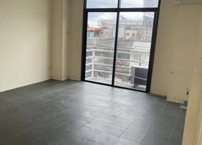 Spacious living room with large window and balcony view