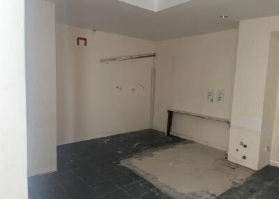 Unfinished room with tiled flooring and a partial wall opening